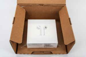 Apple AirPods 2 in shipping box, opened, white background, Apple AirPods 2 in shipping box, opened, white background,